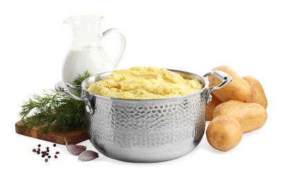 Pot of tasty mashed potatoes near ingredients on white background