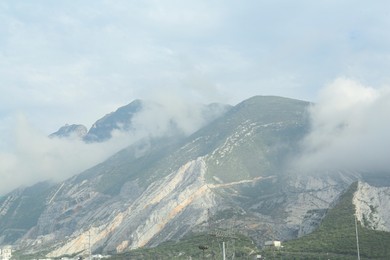Picturesque landscape with mountains under thick fog