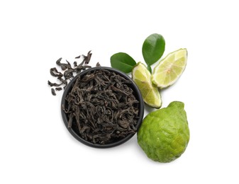 Dry bergamot tea leaves and fresh fruits on white background, top view