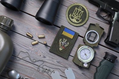 MYKOLAIV, UKRAINE - SEPTEMBER 19, 2020: Flat lay composition with Ukraine military equipment on grey wooden table
