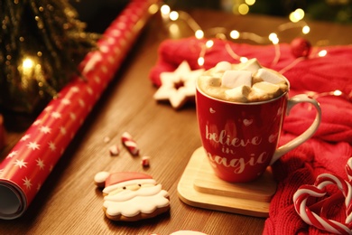 Tasty hot drink in cup with inscription Believe in Magic, space for text. Christmas atmosphere