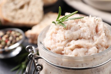 Photo of Delicious lard spread with rosemary in jar, closeup