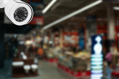 Image of Modern CCTV security camera in shopping mall. Guard equipment