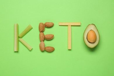 Word Keto made with different products on light green background, flat lay