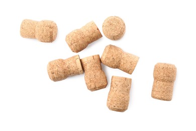 Many sparkling wine corks on white background, top view