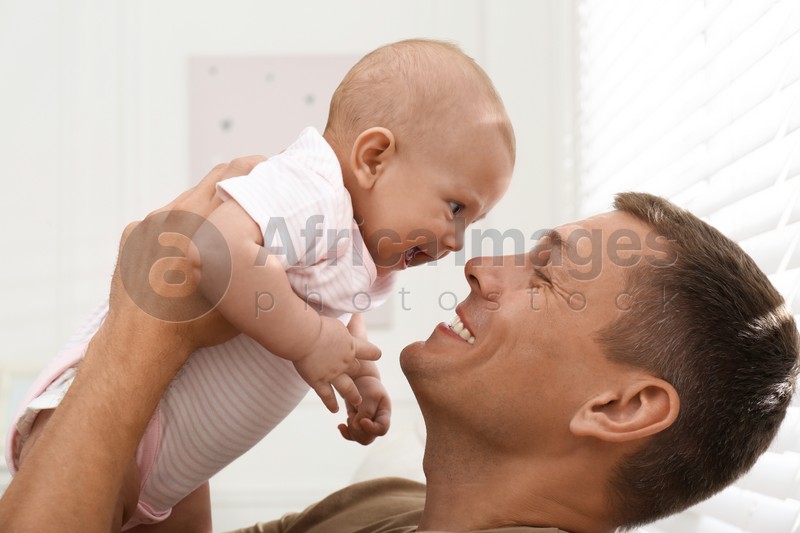 Happy father with his little baby at home