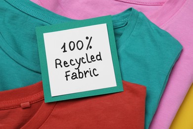 Photo of Different clothes with recycling label, closeup view