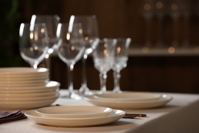 Photo of Clean dishware and glasses on table indoors
