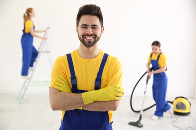 Professional janitor in uniform indoors. Cleaning service