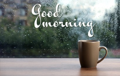 Cup of hot drink near window on rainy day. Good morning
