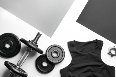 Flat lay composition with sportswear and equipment on color background, space for text. Gym workout