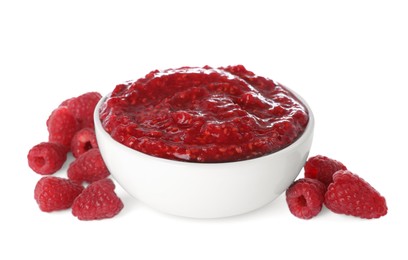 Raspberry puree in bowl and fresh berries on white background