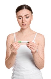 Photo of Woman with rash holding thermometer on white background. Monkeypox virus