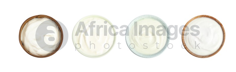 Set of delicious natural yogurt in bowls on white background, top view. Banner design