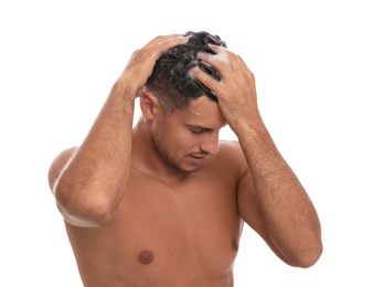 Handsome man washing hair on white background