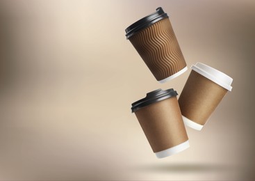 Image of Collage with falling takeaway paper cups on light brown background. Space for text