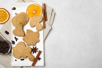 Flat lay composition with baked biscuits of different shapes on light table. Space for text