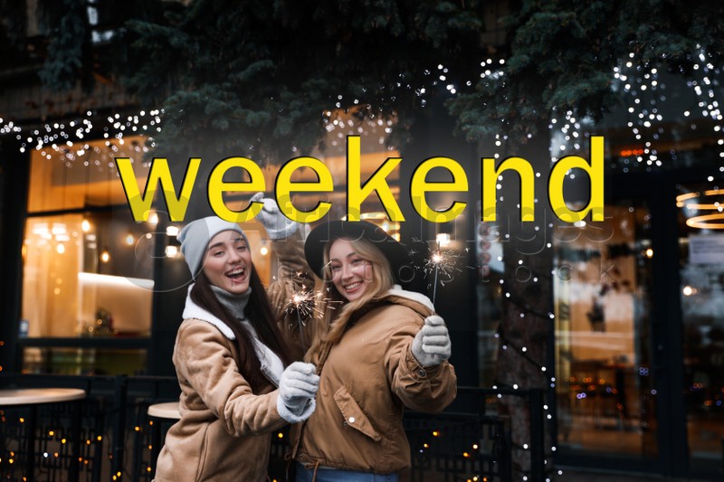 Hello Weekend. Happy young women with sparklers at winter fair