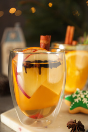 Aromatic white mulled wine in glass on board, closeup