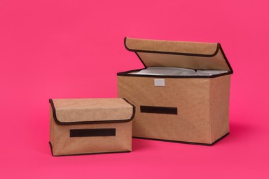 Two textile storage cases on pink background