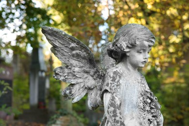 Photo of Beautiful statue of angel at cemetery. Religious symbol