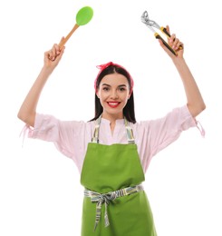 Photo of Young housewife with pliers and spatula on white background