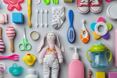 Flat lay composition with baby accessories and toys on gray background