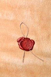 Photo of Sheet of old parchment paper with wax stamp as background, top view