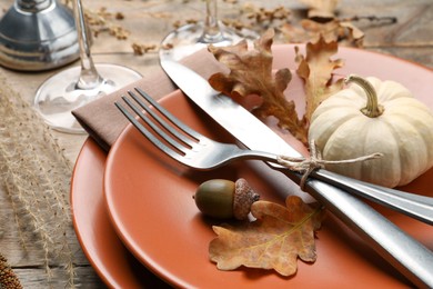 Festive table setting with autumn decor on wooden desk, closeup