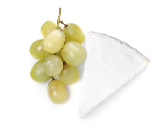 Tasty brie cheese with grapes on white background, top view