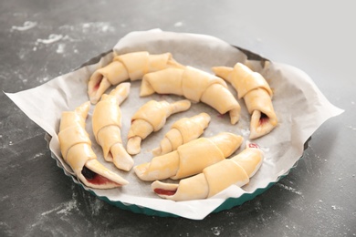 Baking dish with raw croissants on table