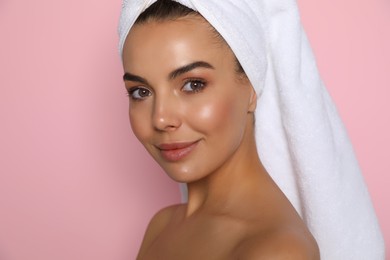 Photo of Beautiful young woman with towel on head against pink background