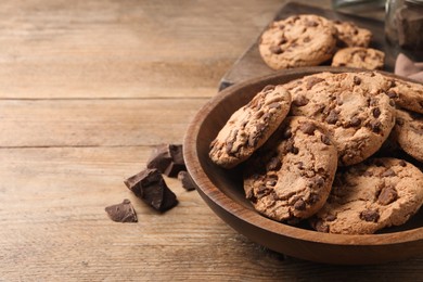 Delicious chocolate chip cookies on wooden table. Space for text