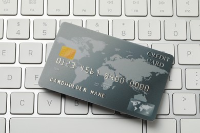 Photo of Online payment concept. Bank card on computer keyboard, closeup