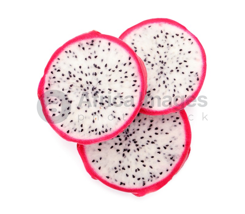 Slices of delicious pitahaya fruit on white background, top view