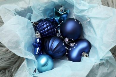 Beautiful Christmas baubles in box on faux fur