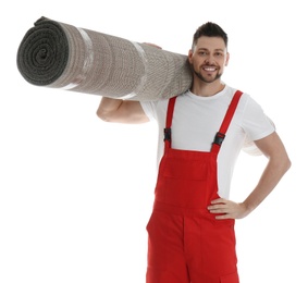 Male worker with rolled carpet on white background
