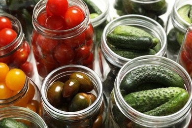 Pickling jars with fresh vegetables, closeup view