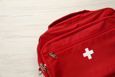 First aid kit bag on white wooden table, closeup