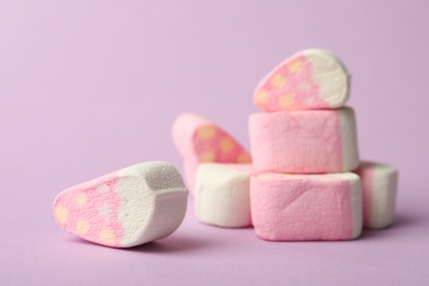 Pile of strawberry shaped marshmallows on pink background, closeup. Space for text