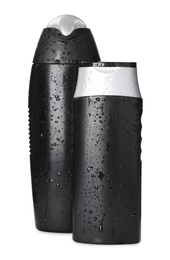 Black bottles covered with water drops isolated on white. Men's cosmetics