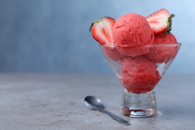 Delicious strawberry ice cream served on grey table. Space for text