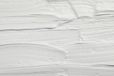 Texture of white oil paint as background, closeup