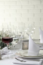 Glass of delicious wine and elegant table setting in restaurant