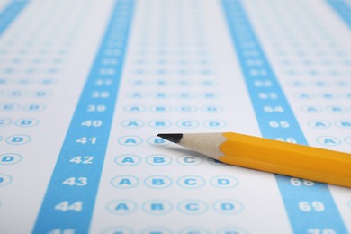 Photo of Pencil on answer sheet, closeup. Student passing exam
