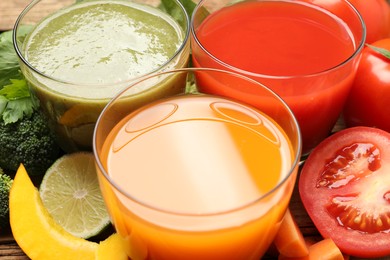 Photo of Delicious vegetable juices and fresh ingredients on table, closeup