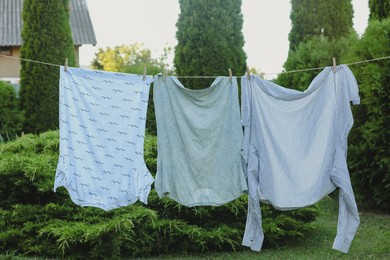 Shirts drying on washing line at backyard of house