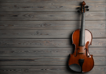 Classic violin on wooden background, top view. Space for text