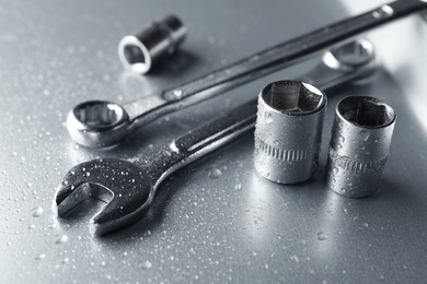 Auto mechanic's tools on metallic surface, closeup