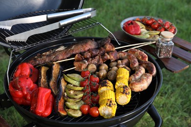 Tasty meat and vegetables on barbecue grill outdoors